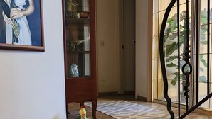 A staircase leading to a landing with a glass cabinet and a painting on the wall. - Welcoming villa with AC in charming Herut with calm atmosphere and lot of space (Herut)