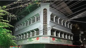 A multi-story building with signage for Aroma Serviced Villas and Aroma Food Products. - Aroma Serviced Villa (Kanayannur)