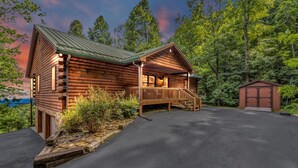 A log cabin with a porch and a small shed. - Gateway Getaway with Mountain Views and Fireplace (Old Fort)