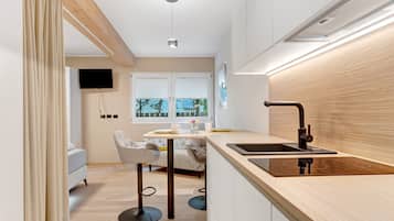 Fridge, stovetop, dishwasher, coffee/tea maker