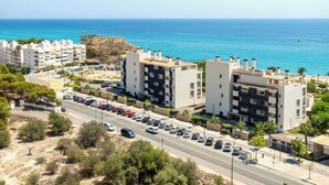 A coastal residential area with modern apartment buildings, a main road, and a view of the sea. - Paradise View (Villajoyosa)