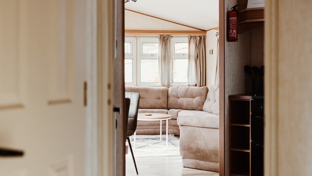 A cozy living area with a sofa, a small round table, and a bookshelf.