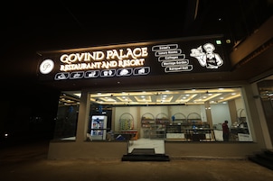 A restaurant with a neon sign advertising various services including a banquet hall.