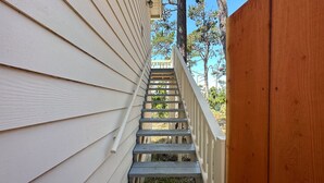 A wooden staircase leading up to a porch with white siding. - Charming Carmel Cottage Ocean & Mntn View Walk DT (Carmel)