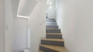 A staircase with patterned tiles and a modern design. - Room 'Camera Furore Sea View' with Sea View, Wi-Fi and Air Conditioning (Furore)