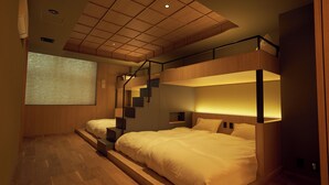 A modern bedroom with a bunk bed, wooden flooring, and a staircase leading to an upper level. - UCHIWA STAY Osaka NAMBA (Osaka)