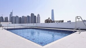 A rooftop pool with a city skyline view. - Dancenter Retreat Sheikh Zayed Road (Dubai)