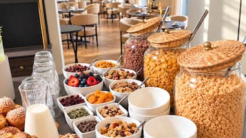 A breakfast buffet with various food items and a coffee station.