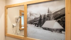 A framed black and white photograph of a cabin in a snowy landscape with mountains in the background. - AMI ZAKOPANE (Zakopane)