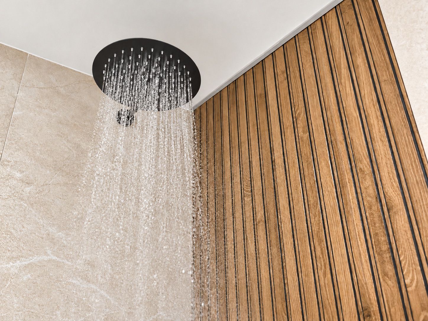 A shower with water flowing from a circular drain.