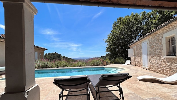 A poolside area with two lounge chairs, a stone building, and a view of the landscape. - Adorable house with  swimming pool and panoramic view (Villeneuve)