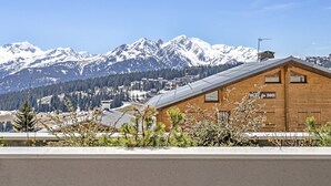 A wooden cabin with a sign reading "Hotel du Bois" in a mountainous area with snow-covered peaks in the background. - Luxury apartment spa & parking, Les Saisies, 11 people (Les Saisies)