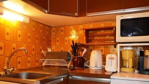A kitchen with a stainless steel sink, a microwave, and a coffee maker. - Mountain Studio for 4 at Ski Slopes (Le Grand-Bornand)