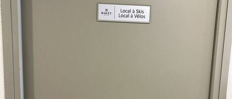 A door with a sign indicating directions to local ski and cycling facilities.