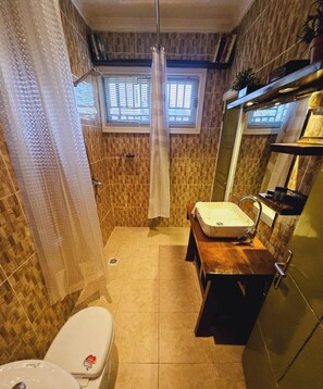 A bathroom with a shower, toilet, and sink. - The Retreat (Yaoundé)