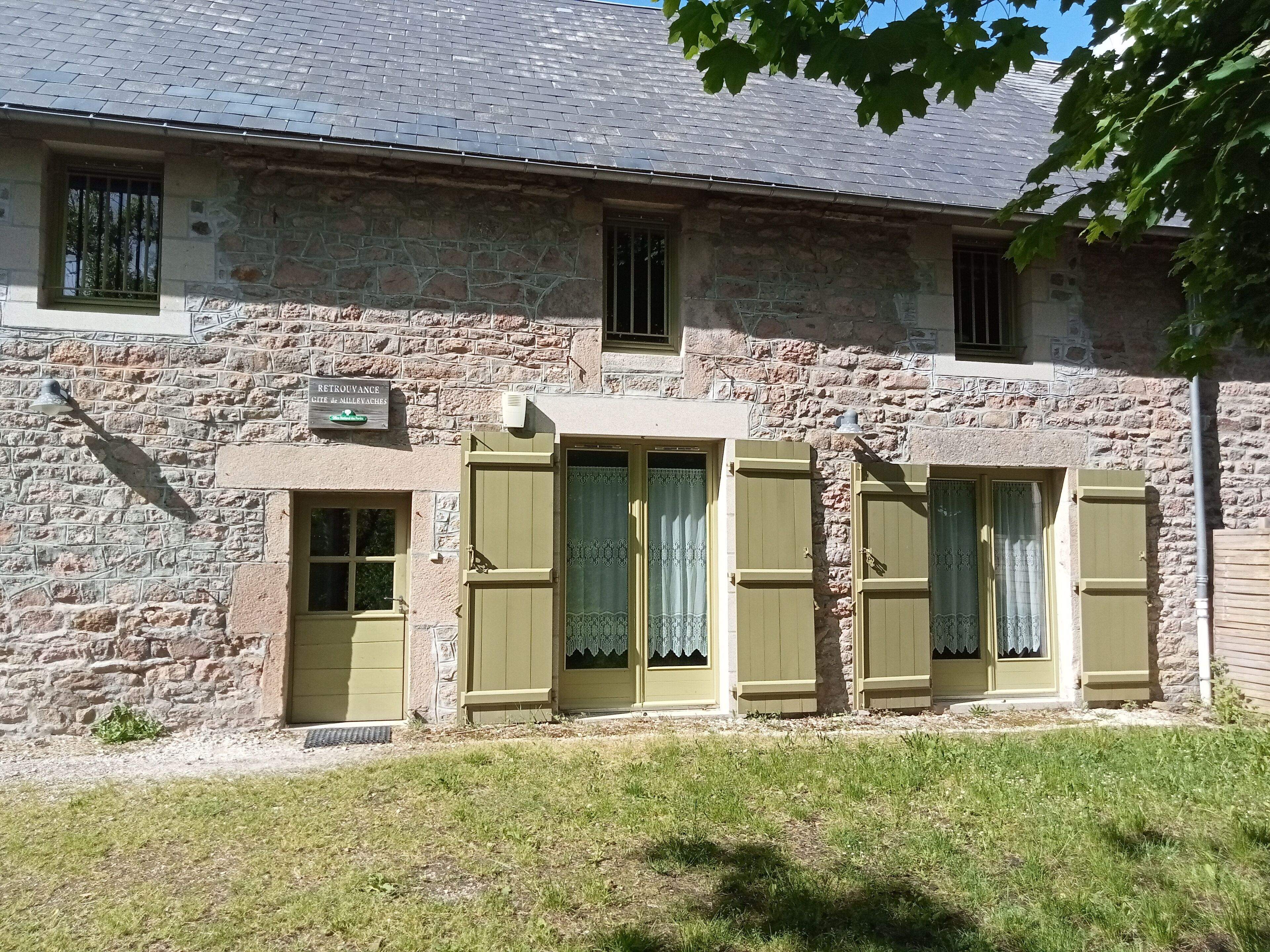A stone building with a sign indicating a restaurant.