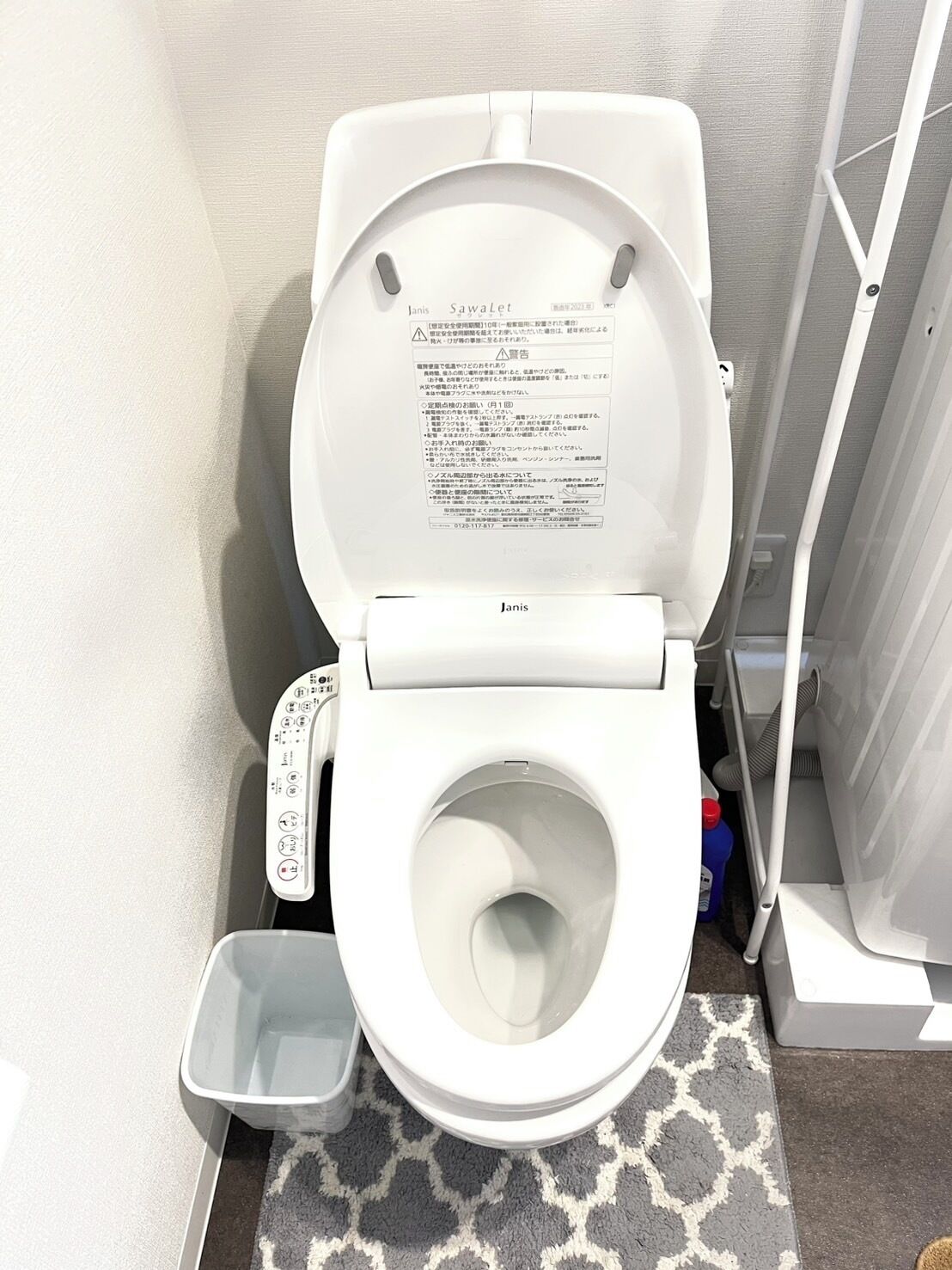 A Janis SawaLet toilet with a control panel and a foot pedal.