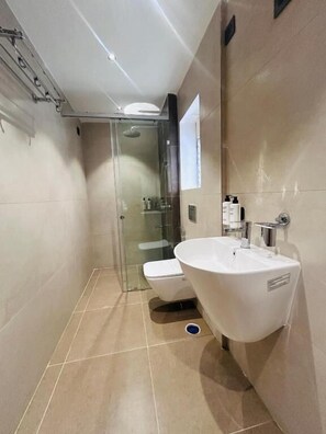 Suite Exécutive | Salle de bain | Serviettes fournies, savon, shampoing, papier toilette