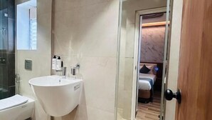 A modern bathroom with a large sink, a mirror, and a shower. - Twenty Three Urban Square Madhapur (Hyderabad)