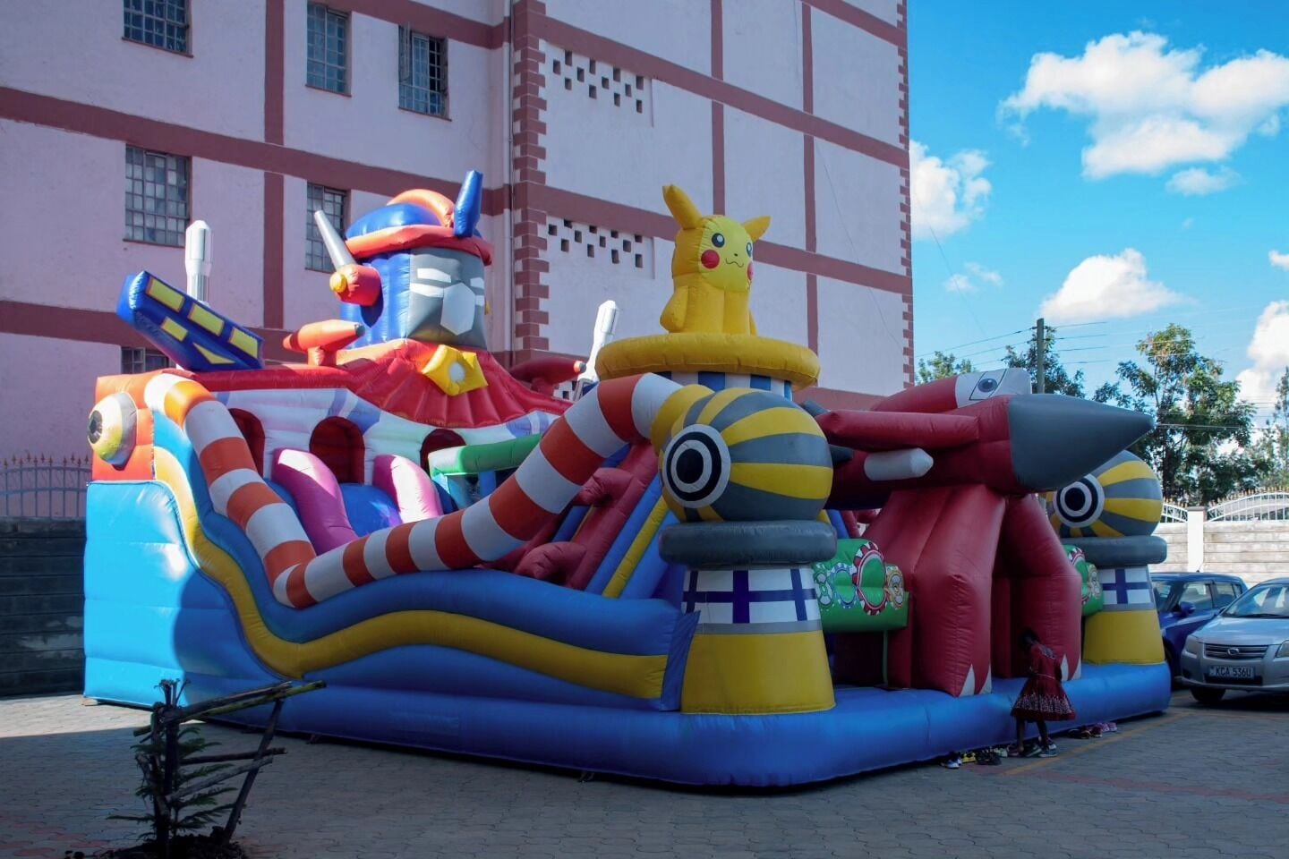 A colorful inflatable play structure with various characters and shapes.