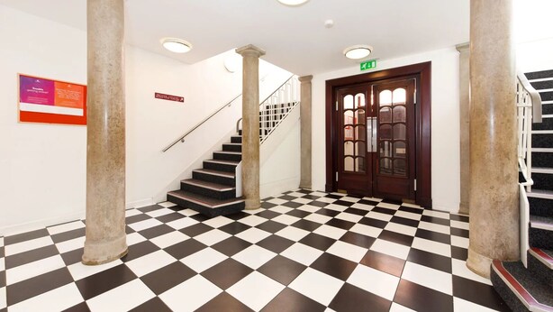 A checkered floor, a staircase, and a door with glass panels. - For Students Only Newarke St (Leicester)