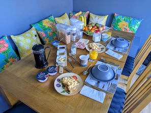 A breakfast setup with a coffee maker, fruit, cereal, and a plate of toast. - A perfect location for the airport and the city, comfortable stay home from home (Currie)