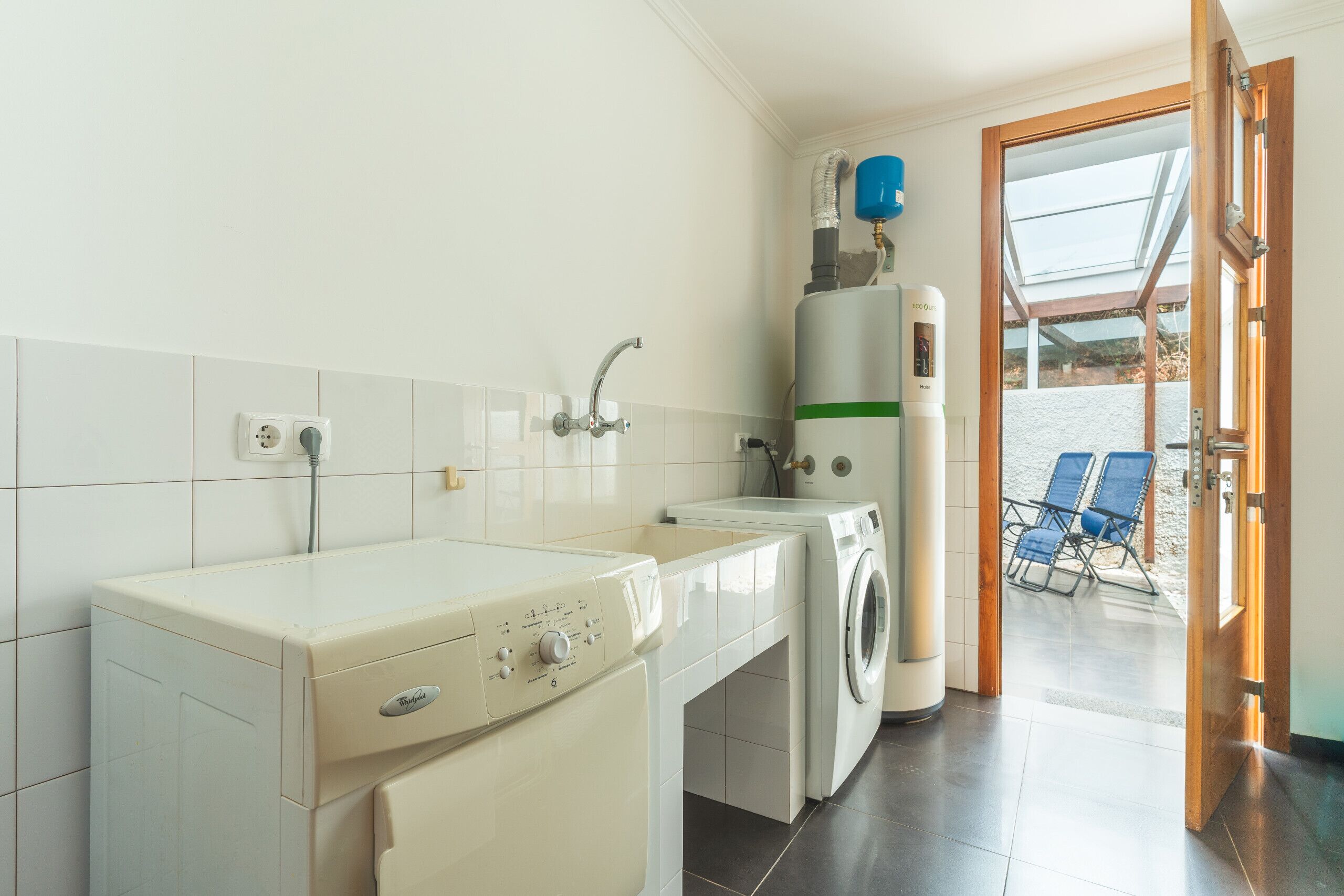 A laundry area with a washing machine, dryer, and a water heater.