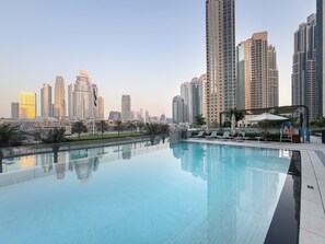 2 outdoor pools, open 6:00 AM to 10:00 PM, pool umbrellas, pool loungers