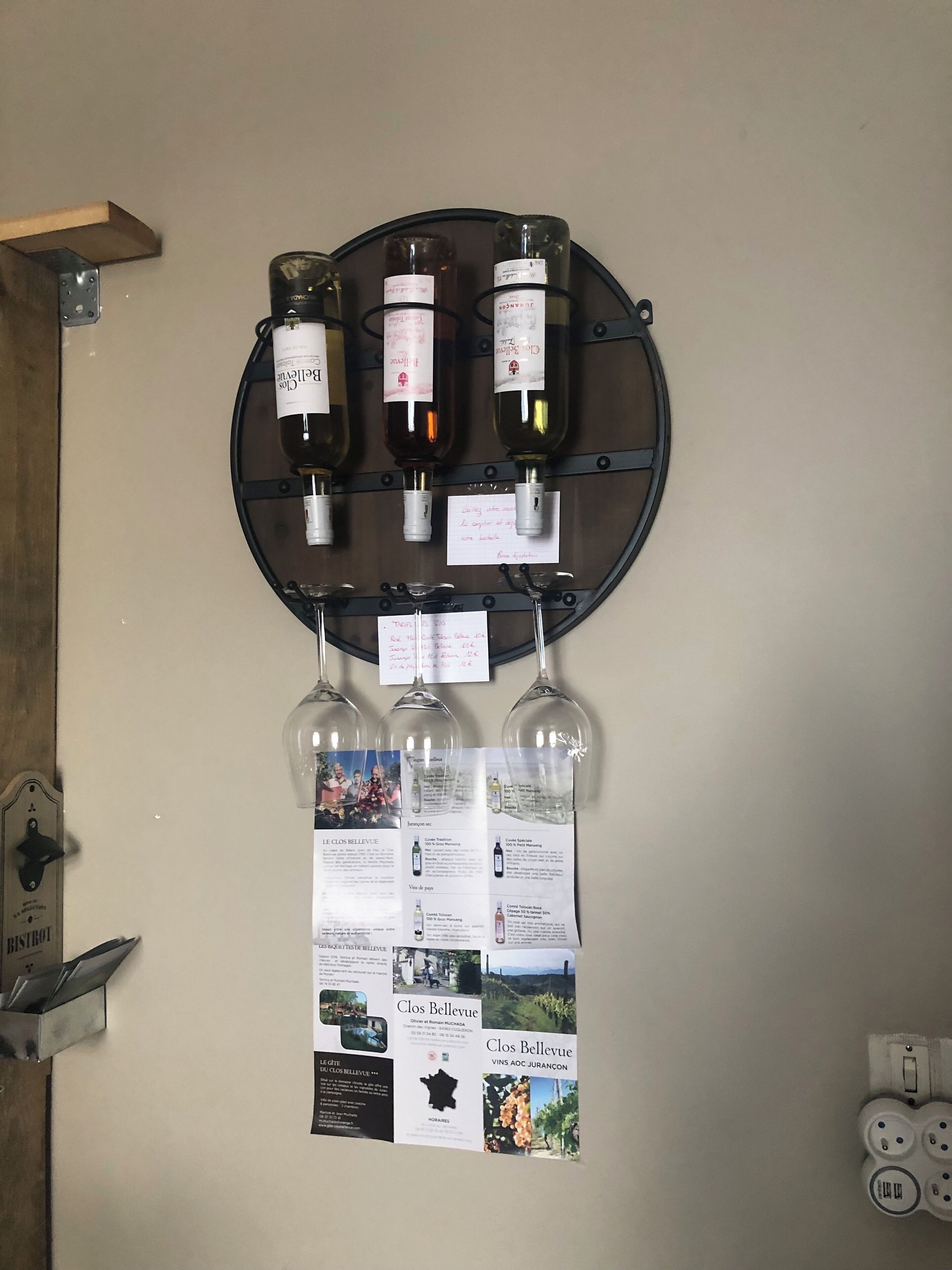 A wine rack with bottles and informational cards.