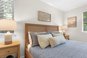 A bedroom with a bed, two bedside tables, a nightstand, and a window with blinds. - Yards to the beach, charming cottage (Kiawah Island)