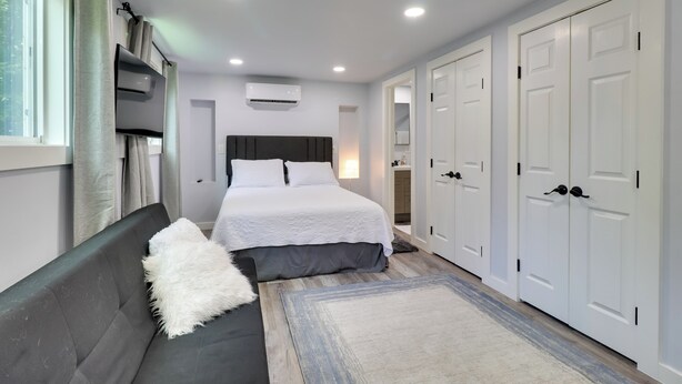 A modern bedroom with a bed, a sofa, and a wardrobe. - 1 Mi to Dtwn: Renovated Retreat in Georgetown! (Georgetown)