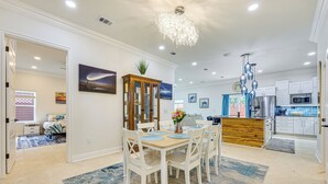 A modern kitchen with white cabinets, a stainless steel refrigerator, and a wooden island. - 'the Blue Oasis' Group Getaway! Walk to Jax Beach (Jacksonville Beach)