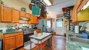A kitchen with wooden cabinets, a stove, and a sink. - Hot Tub + Pet Friendly: Quiet French Creek Getaway (French Creek)