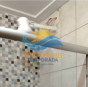 A tiled wall with a patterned design and a sun logo.
