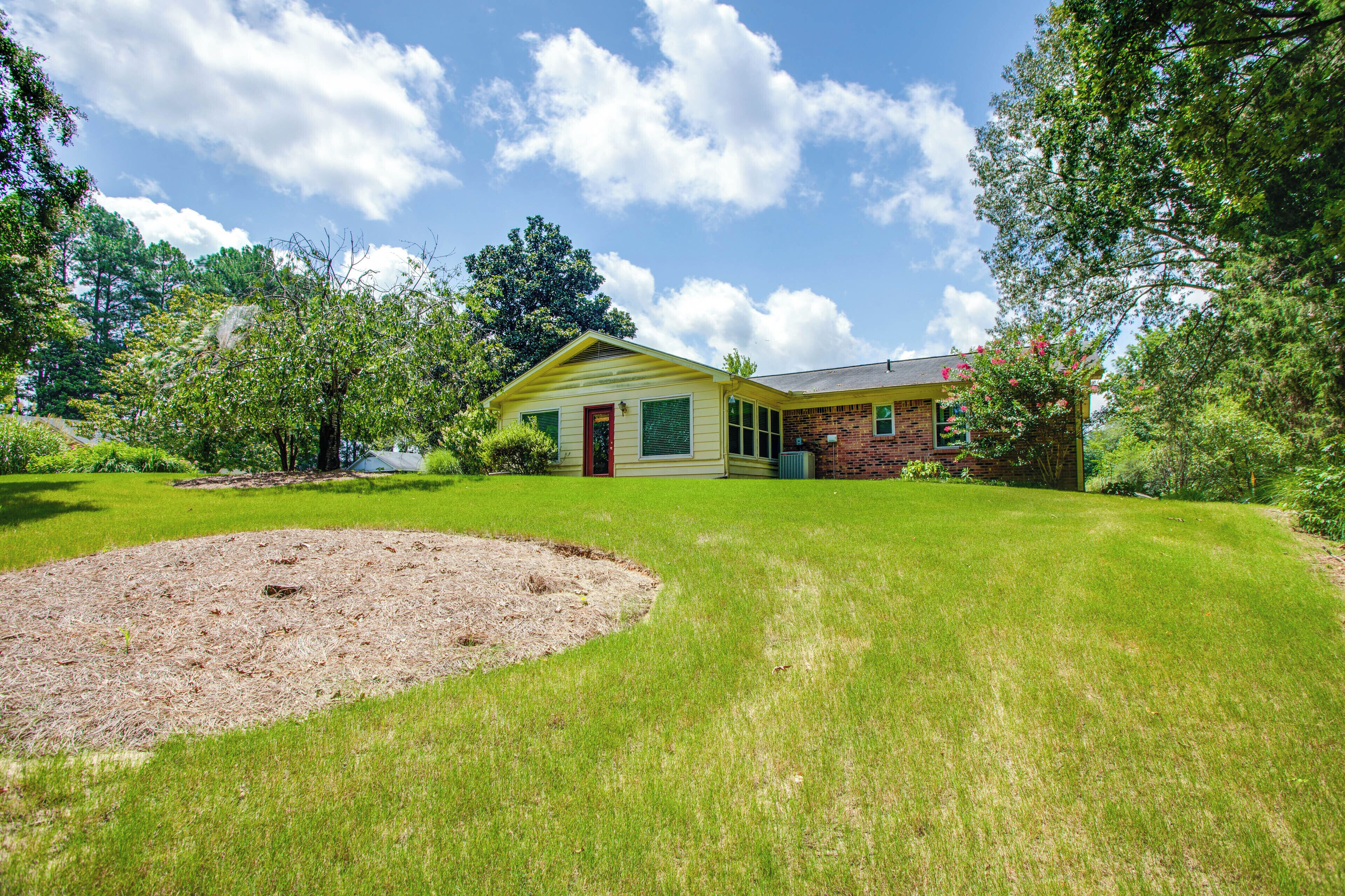 A house with a well-maintained lawn and a small garden area.