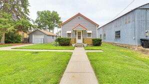 A residential house with a front yard, a garage, and a large metal building to the right. - Dtwn Belleville Home w/ Yard < 1 Mi to High Banks (Belleville)
