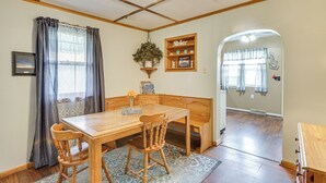 A dining area with a wooden table and chairs, a bench, a hanging plant, and a 'Relax' shelf. - Dtwn Belleville Home w/ Yard < 1 Mi to High Banks (Belleville)