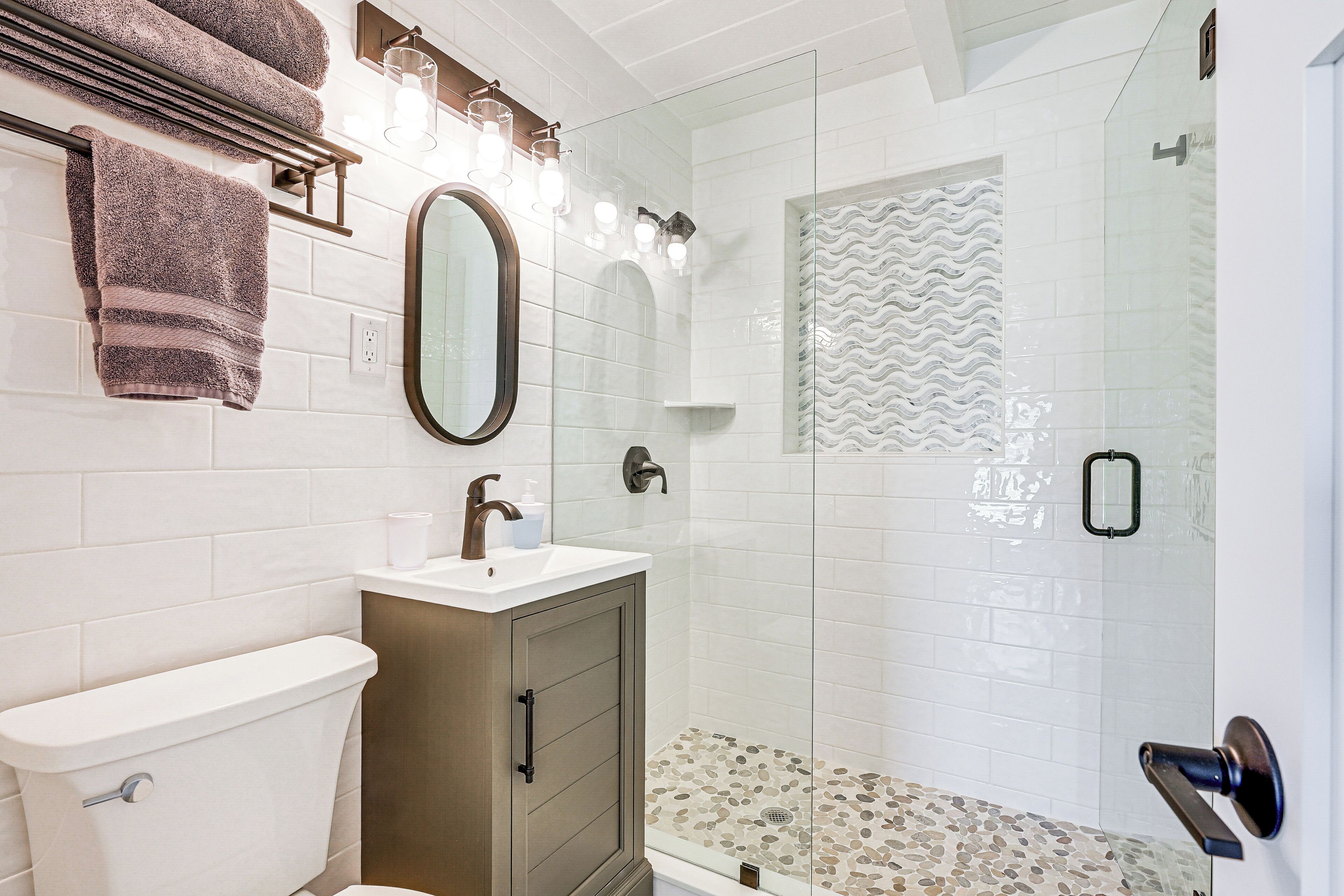 A bathroom with a toilet, sink, and shower.