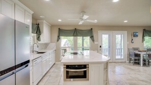 A spacious kitchen with white cabinetry, a built-in oven, and a large island. - Waterfront Lake Bridgeport Home w/ Private Dock (Bridgeport)