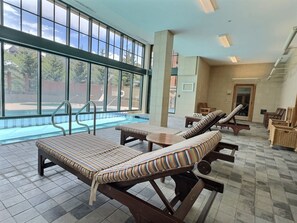 A poolside area with lounge chairs and a view of the pool. - NEW LISTING | King Room at Base, Pool & Hot Tub (Crested Butte)