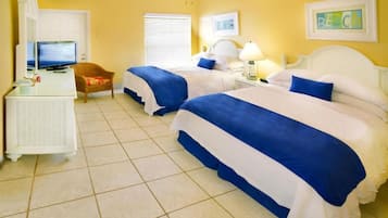 A hotel room with two beds, a television, a desk, and a chair.