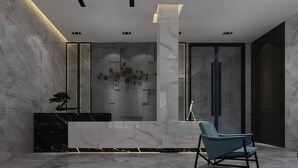 A modern reception area with marble walls, a black marble counter, a blue chair, and a minimalist decor. - CANTON ISLE HOTEL (Guangzhou)