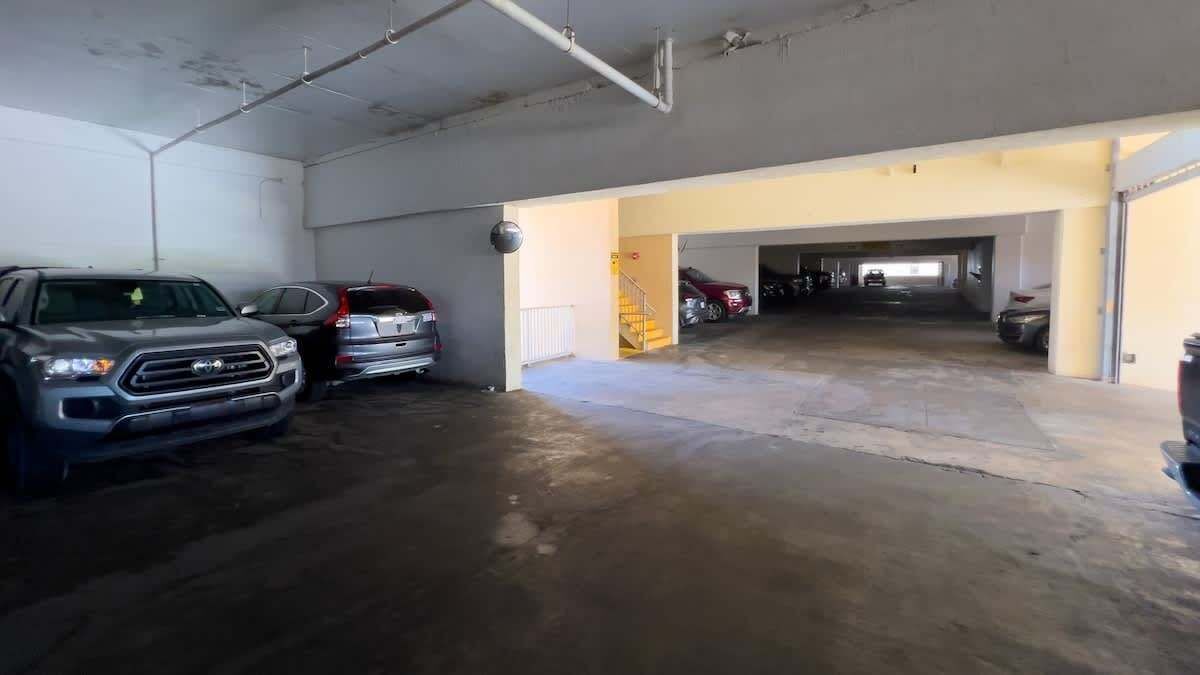 A multi-level parking garage with several cars parked.