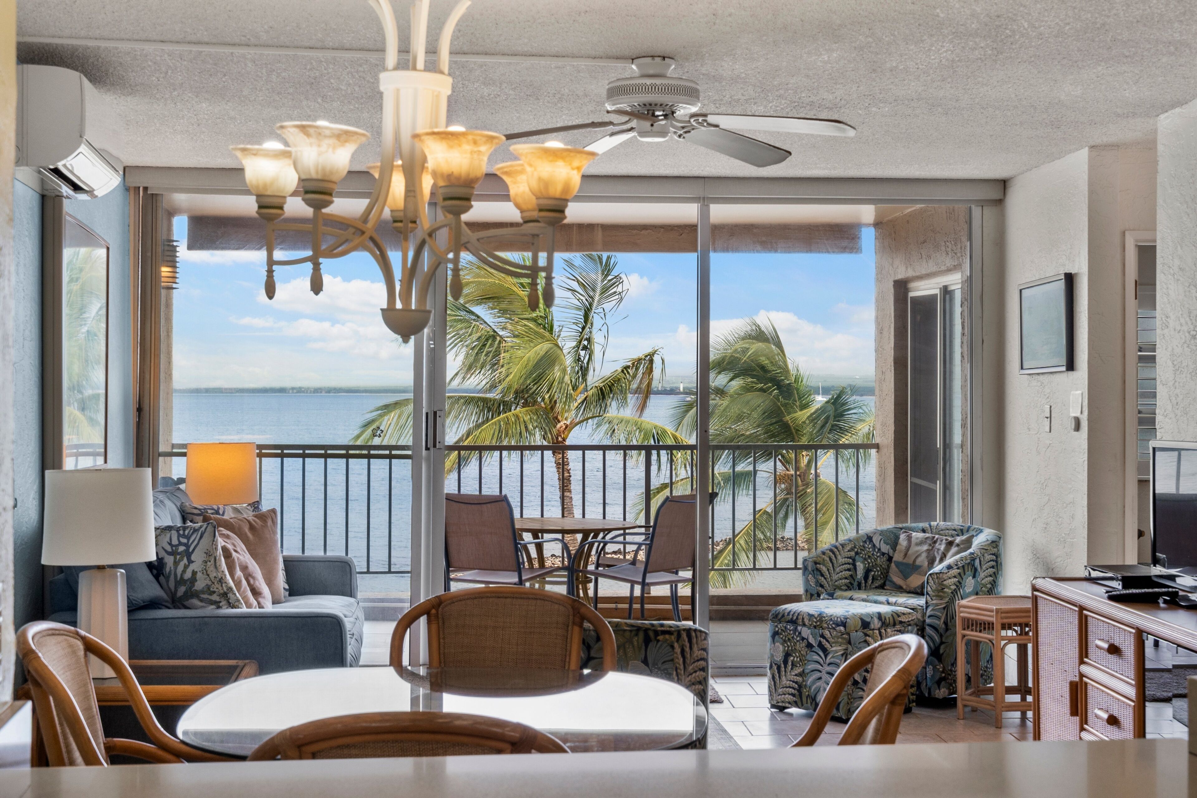 A spacious living area with a balcony overlooking a scenic view.
