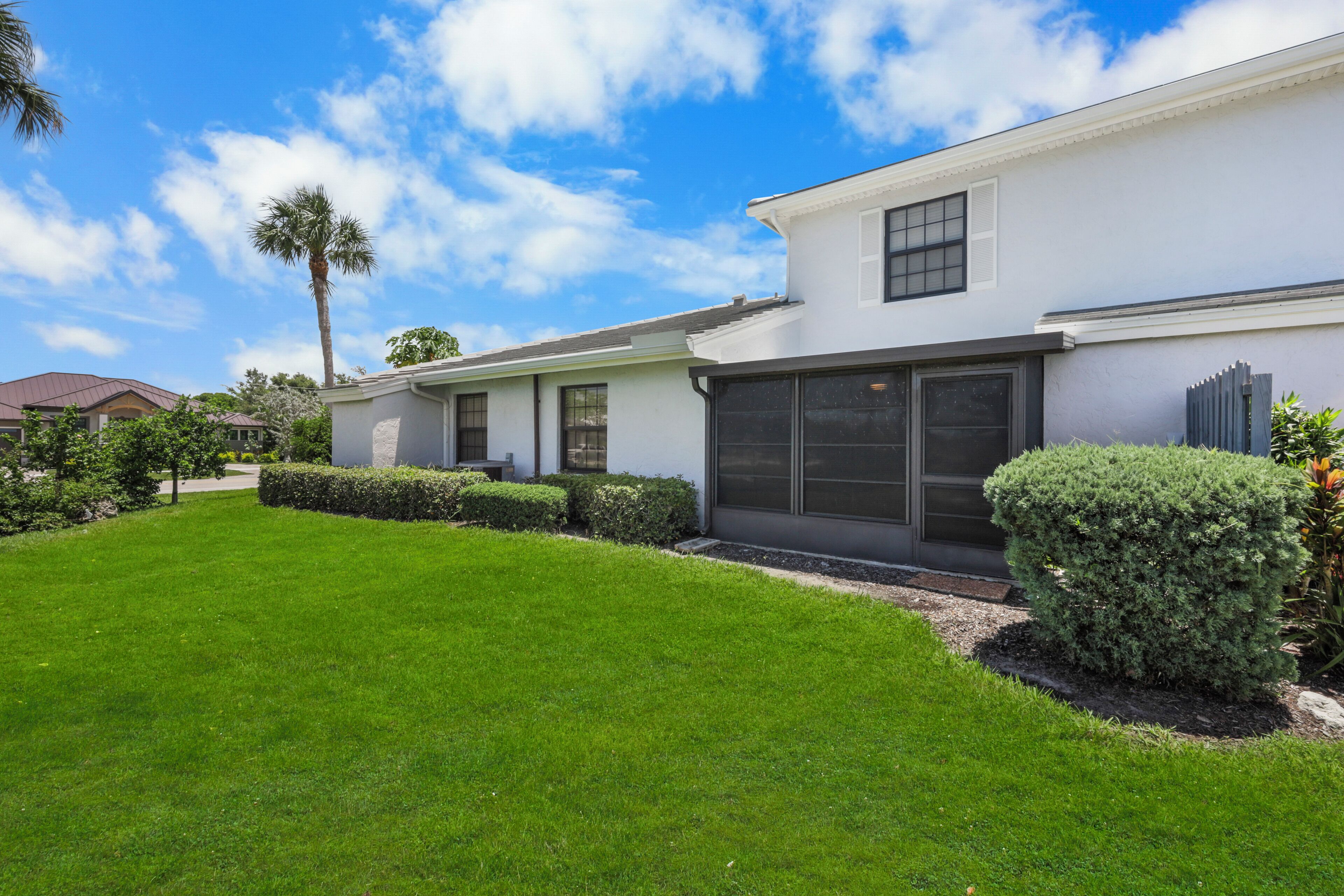 A modern two-story house with a well-maintained lawn and a garage.