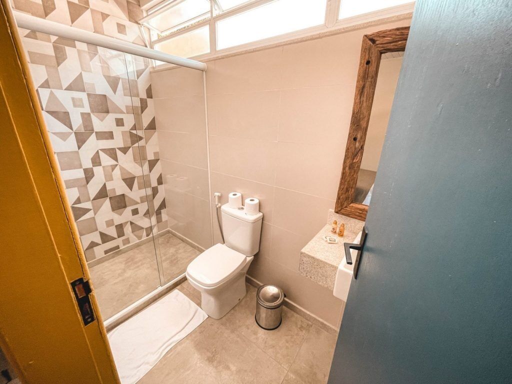 A bathroom with a shower, toilet, and sink.