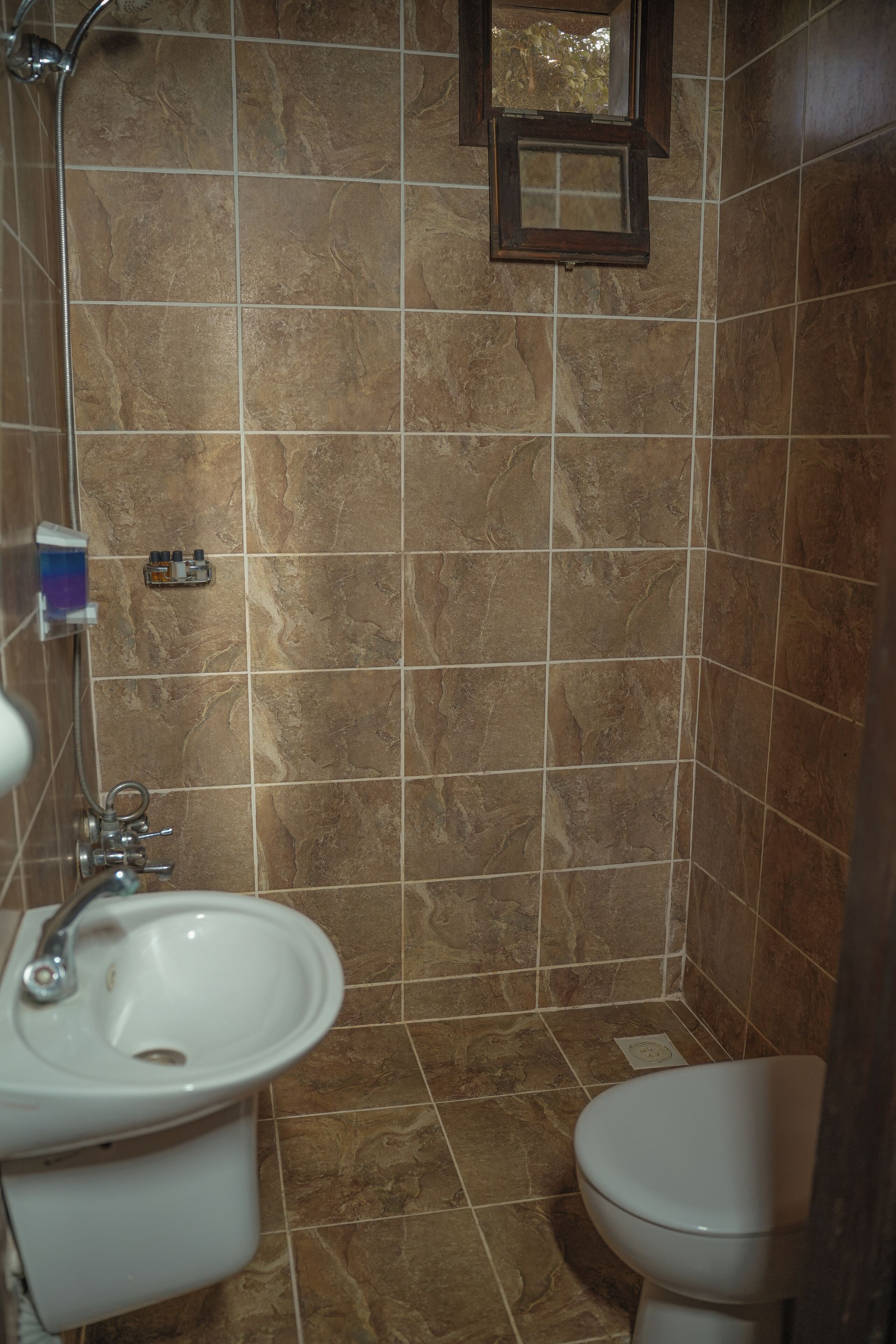 A bathroom with a sink, toilet, and shower.