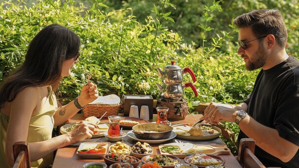 A dining table set outdoors with various dishes and a coffee pot. - SAKLI VADİ (Selcuk)