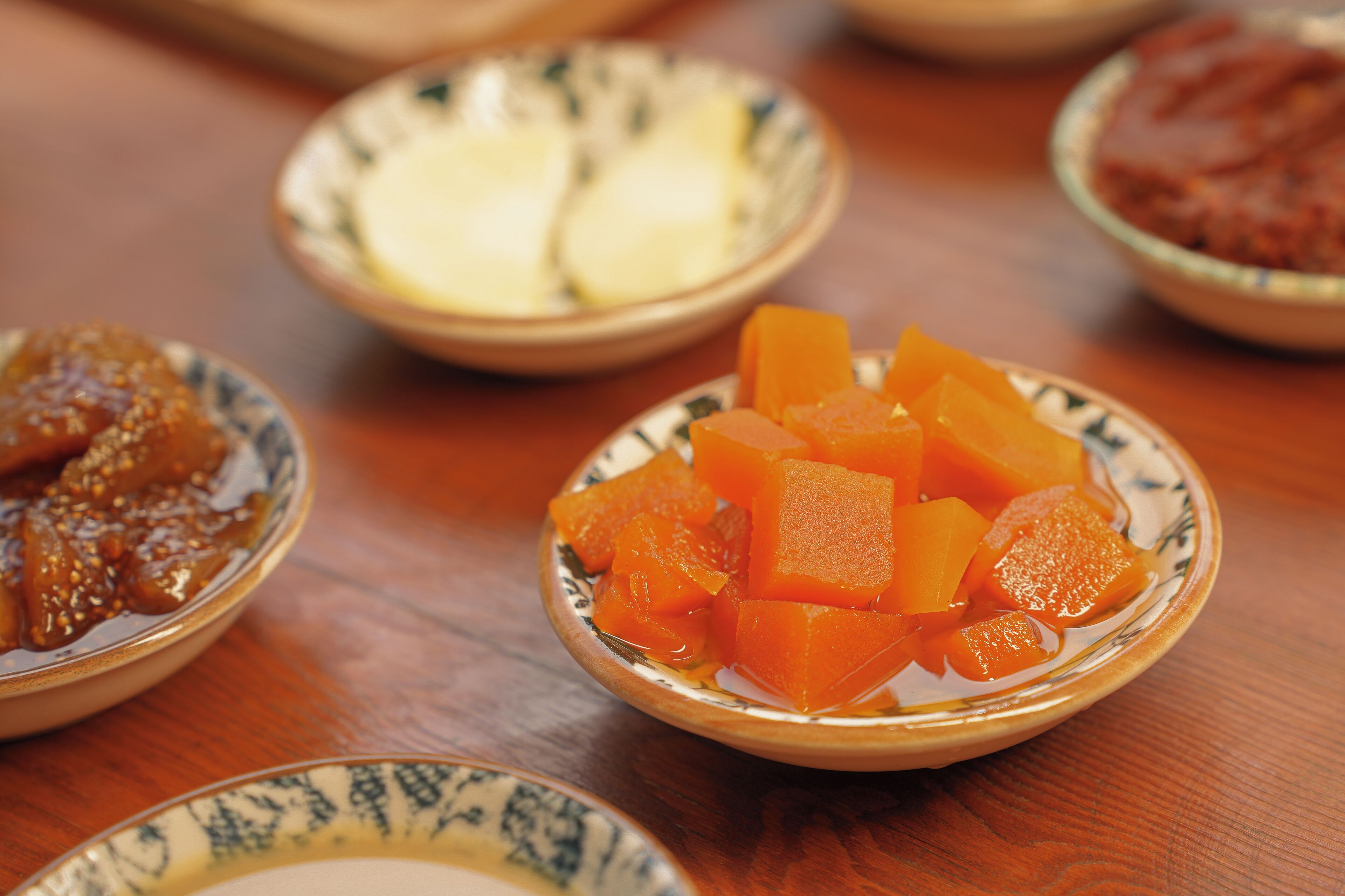 A table with several bowls containing different food items.