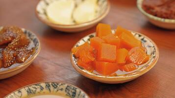 A table with several bowls containing different food items.